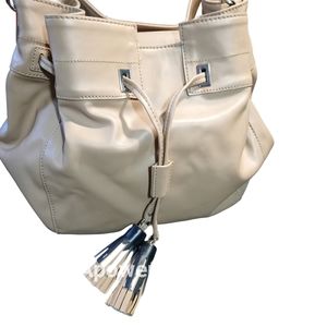 Ñine west purse, tan or taupe color large bucket type bag with tassels. Like new